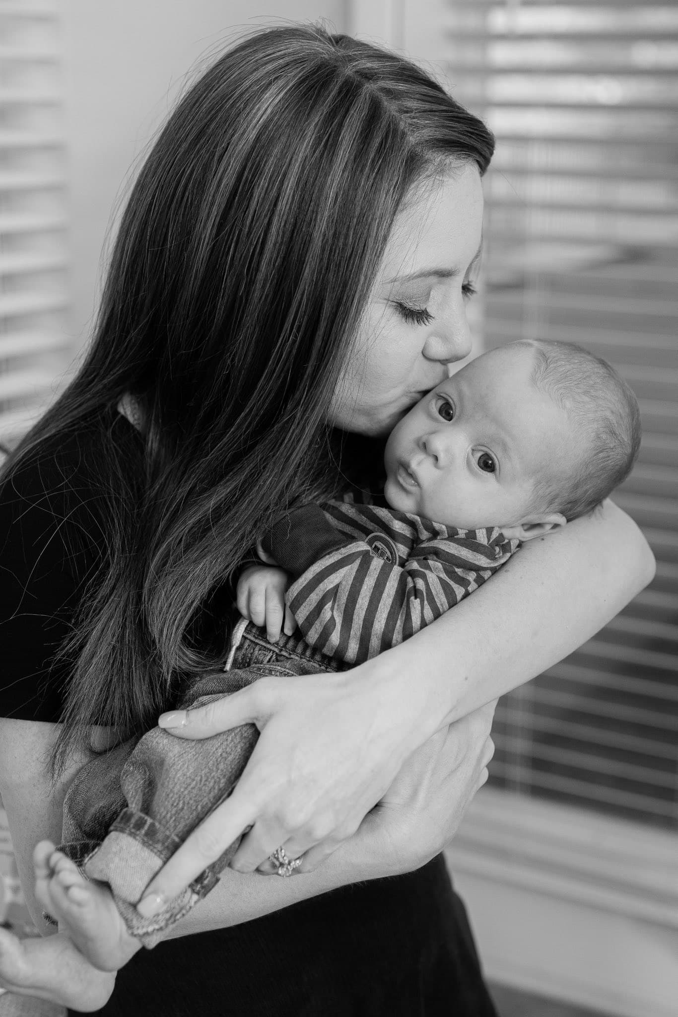 Newborn baby with mother in black and white